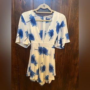 VERY CUTE white romper with blue flowers and back tye
